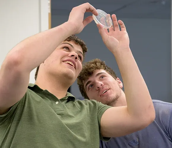 Two science students examining a sample